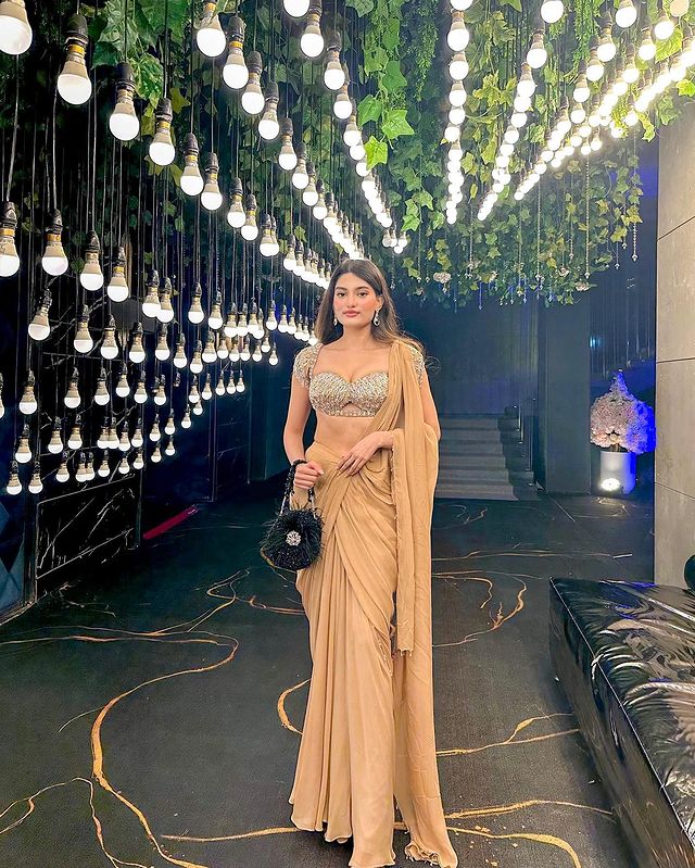 Medha Das Sharma in Nude Drape Saree With Bralette Blouse & Tasseled Sleeves